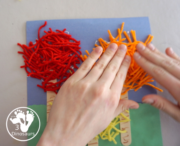 Yarn Truffula Trees - a fun and easy craft for the book The Lorax and Earth Day. You use paper, craft sticks and yarn to make the truffula trees. 3Dinosaurs.com