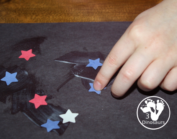 Red, White & Blue Star Craft - a fun star punch craft that is easy to do for kids of various ages. Kids will punch out the star and blue them on the black paper. A great Fourth of July Craft. 3Dinosaurs.com