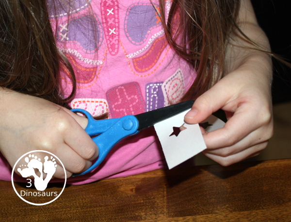 Red, White & Blue Star Craft - a fun star punch craft that is easy to do for kids of various ages. Kids will punch out the star and blue them on the black paper. A great Fourth of July Craft. 3Dinosaurs.com