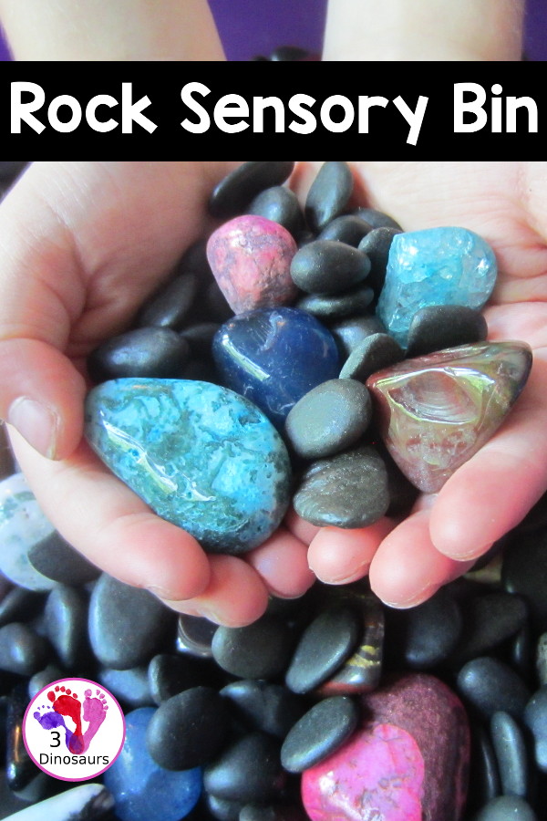 Rock Sensory Bin - a simple rock sensory bin with different shapes and colors of rocks with black rocks as filler for the sensory bin. 3Dinosaurs.com